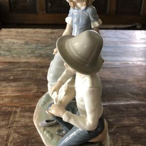 Nao by Lladro Figurine Boy Bandaging Girl Foot